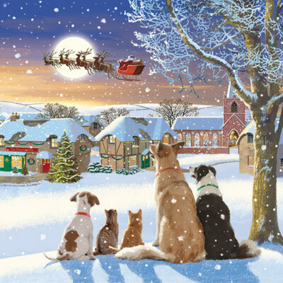 The illustration depicts three dogs and two cats standing next to a snow covered tree and looking up at Santa and eight reindeer flying above a snow covered village.